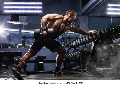 Handsome Man With Big Muscles, Posing At The Camera In The Gym