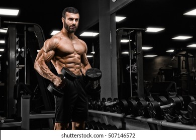 Handsome Man With Big Muscles, Posing At The Camera In The Gym