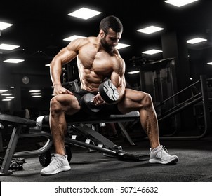 Handsome Man With Big Muscles, Posing At The Camera In The Gym