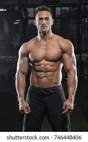 Handsome Man With Big Muscles, Posing At The Camera In The Gym