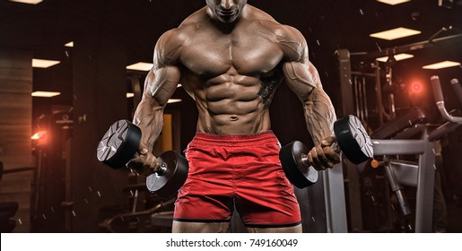 Handsome Man With Big Muscles, Posing At The Camera In The Gym