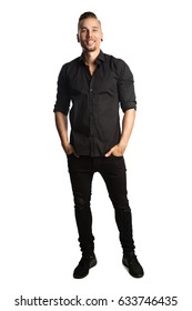 Handsome Man In Black Shirt And Black Jeans, Standing Against A White Background Feeling Great And Comfortable With A Smile.