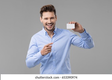 Handsome Man In Blue Shirt  With White Card