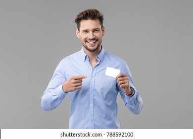 Handsome man in blue shirt  with white card