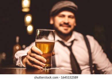 Handsome Man With A Cap At The Pub With A Beer At October Fest 