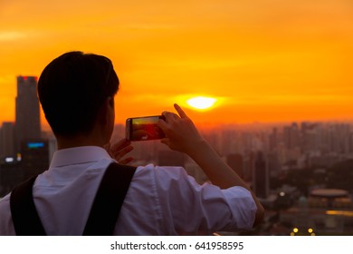 Handsome man capture Marina Bay in Singapore at sunset. - Powered by Shutterstock