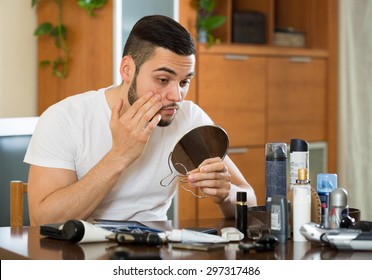 Handsome Man Checking His Eyelid In A Mirror