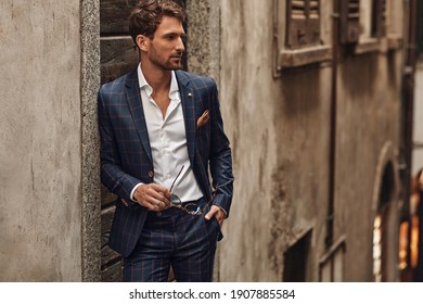 Handsome man in classik checked suit thinking - Shutterstock ID 1907885584
