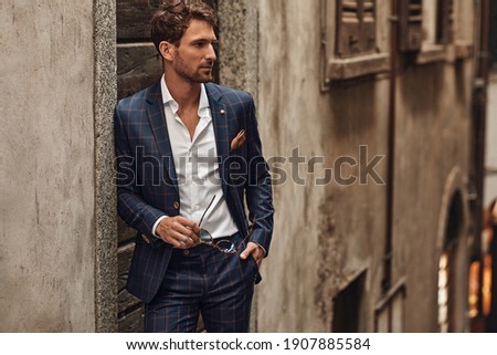 Handsome man in classik checked suit thinking