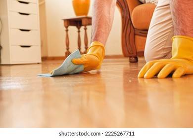 Handsome Man Cleaning Floor In His House With A Piece Of Cloth And Using Gloves, Working Hard