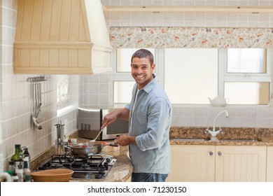 Handsome Man Cooking In The Kitchen At Home