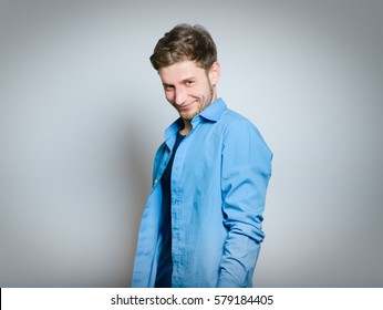 Handsome Man Cunning, Isolated On A Gray Background