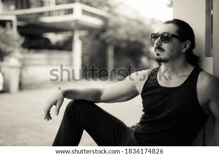 Similar – black haired man posing with sunglasses