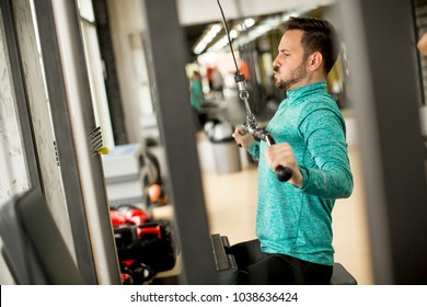 Handsome Man Doing Excersise On A Lat Machine In Gym