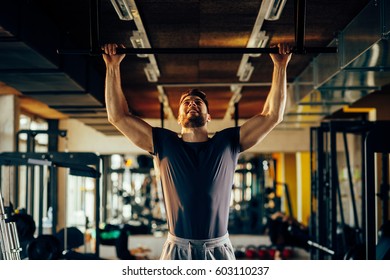 Handsome Man Doing Exercise For Back In The Gym