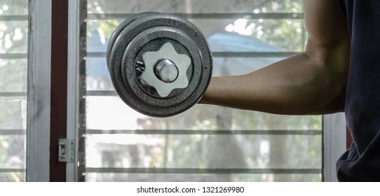  handsome man doing exercise on dummbells