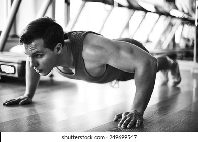 Handsome Man Doing Physical Exercise On The Floor