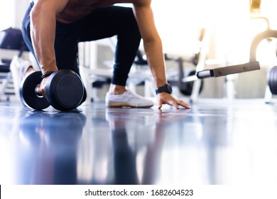 Handsome Man Doing Push Ups Exercise With One Hand In Fitness Gym