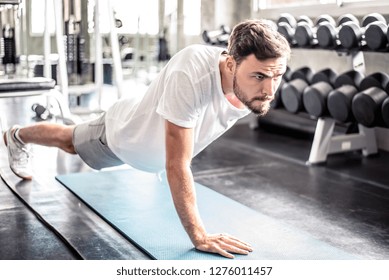 Handsome man Doing Push-Ups workout fitness posture body building exercise exercising in gym