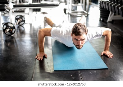 Handsome man Doing Push-Ups workout fitness posture body building exercise exercising in gym