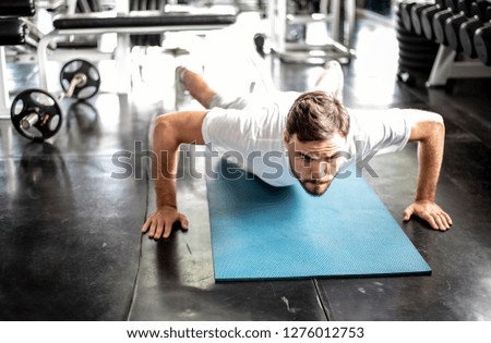 Handsome man Doing Push-Ups workout fitness posture body building exercise exercising in gym