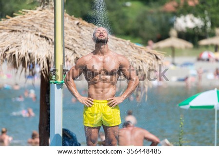 Handsome Man Doing A Shower In A Pool Spa Outdoors