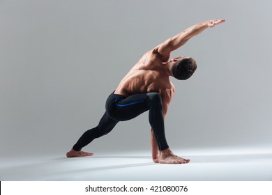 Handsome Man Doing Yoga Exercise Isolated On A White Background