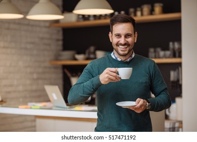 Handsome Man Drinking Coffee At Home In The Kitchen.