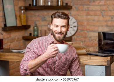 Handsome Man Drinking Coffee At The Kitchen