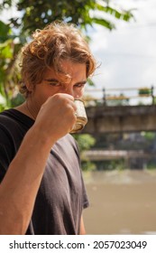 Handsome Man Drinking Hot Tea On A Picnic Outside