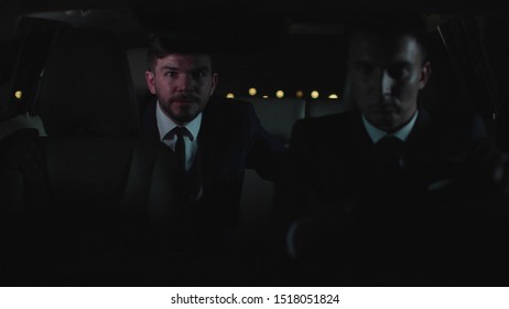 Handsome Man Drive In Car In The Backseat At Night.