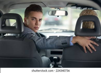 Handsome Man Driver Looking Back And Parking Car