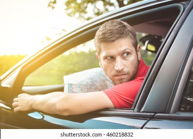 Handsome Man Driver Looking Back And Parking Car