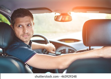 Handsome Man Driver Looking Back And Parking Car