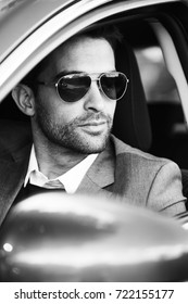 Handsome Man Driving Car In Sunglasses, Looking Away