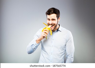 Handsome Man Eating A Banana