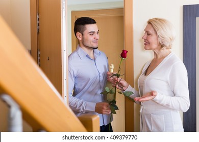  Handsome Man And Elderly Woman Standing At Doorway 