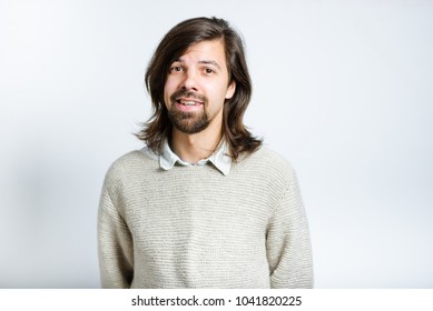 Handsome man embarrassed, with long hair, isolated studio photo