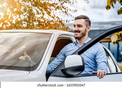 Handsome Man Enjoying His Fresh New Luxury Car Outside