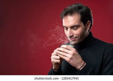 Handsome Man Enjoying The Smell Of His Coffee Or Tea