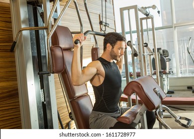 Handsome Man Exercising On Lat Pull Down Machine