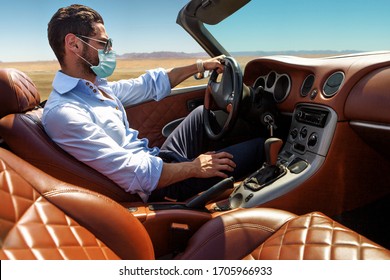 Handsome man in face mask in the car