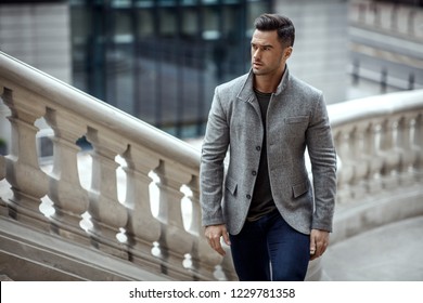 Handsome man in fashinable outfit walking 