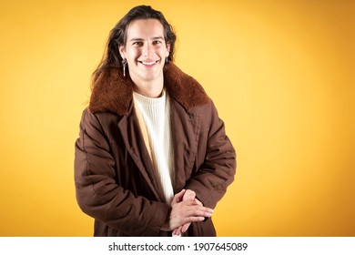 Handsome Man With Folded Hands, Casual Clothes, Very Long Hair, Yellow Background