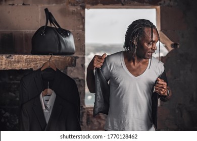 Handsome Man Getting Dressed In A Ruined Place