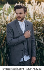 Handsome Man In Gray Suit Posing Against Uruguayan Pampas Grass Background