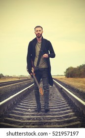 Handsome Man With Guitar On Railroad