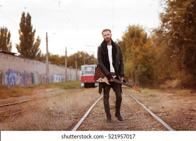 Handsome Man With Guitar On Street