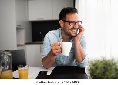 Handsome man having cup of coffee at home in the morning - Powered by Shutterstock