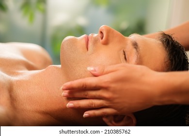 Handsome Man Having Face Massage In Spa Salon